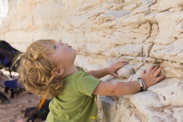 Caucasian baby boy exploring rock formations