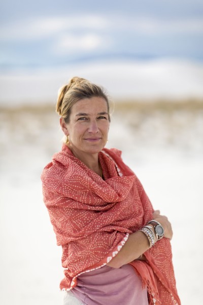 Caucasian woman smiling on sand dune