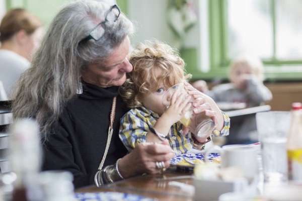 Caucasian grandmother and grandson eating dinner in restaurant
