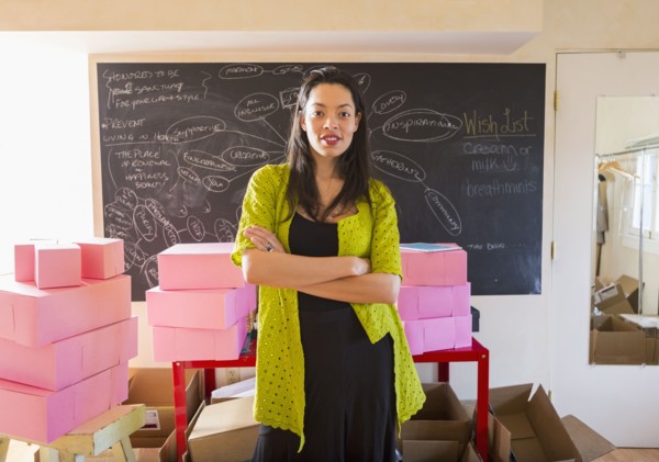 Mixed race businesswoman standing in office