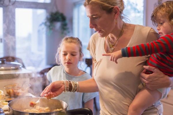 Caucasian mother and children cooking in kitchen
