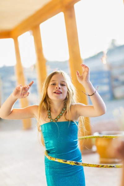 Caucasian girl playing with plastic hoop