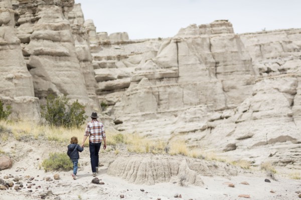 Father and son exploring desert rock formations