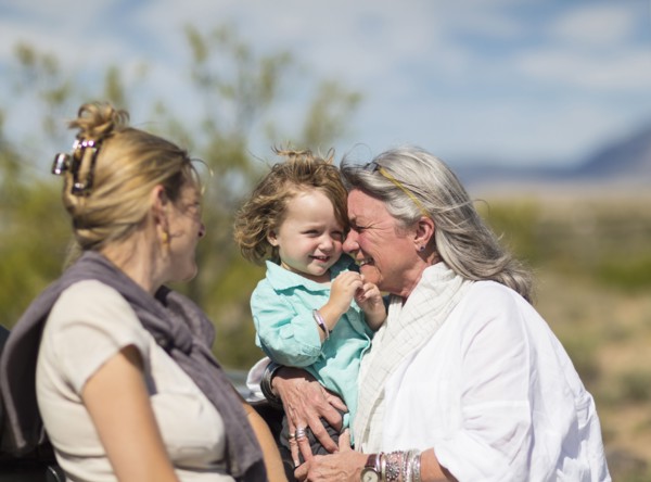 Multi-generation Caucasian family hugging outdoors