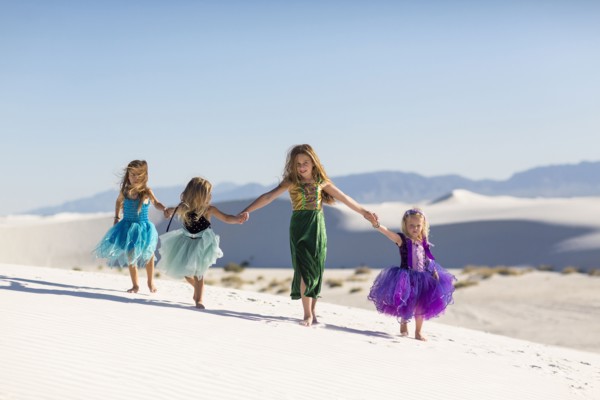 Girls walking on desert sand dunes