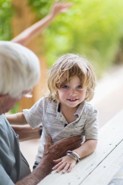 Caucasian grandfather and grandson sitting at table