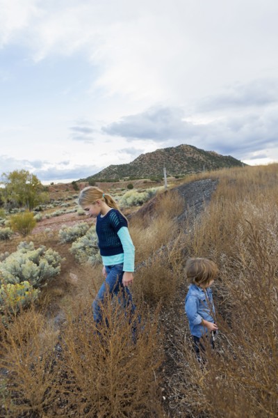 Caucasian children exploring hillside