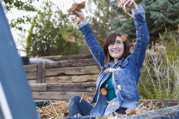 Hispanic woman playing in truck bed
