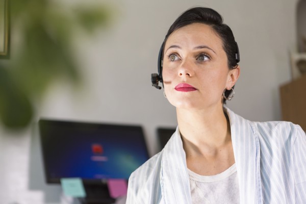Businesswoman wearing headset in office