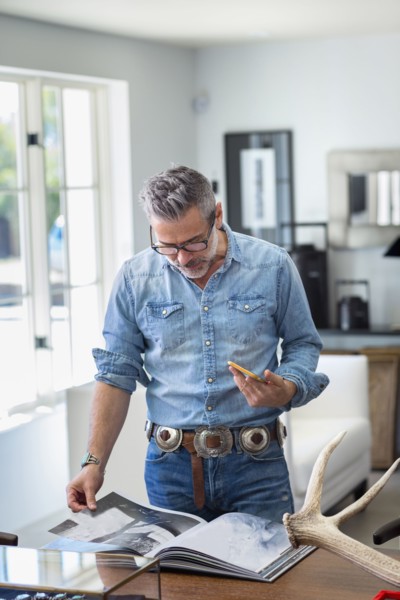 Caucasian man holding staircase reading book