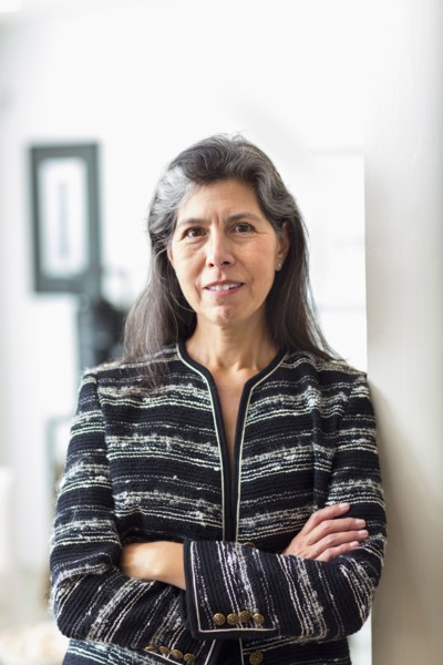 Portrait of Hispanic woman leaning on wall