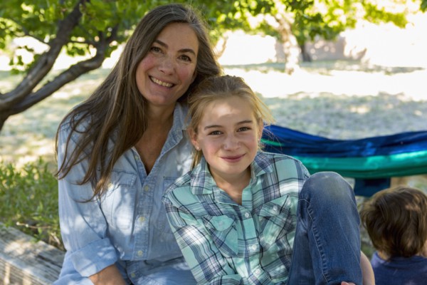 Caucasian grandmother posing with granddaughter