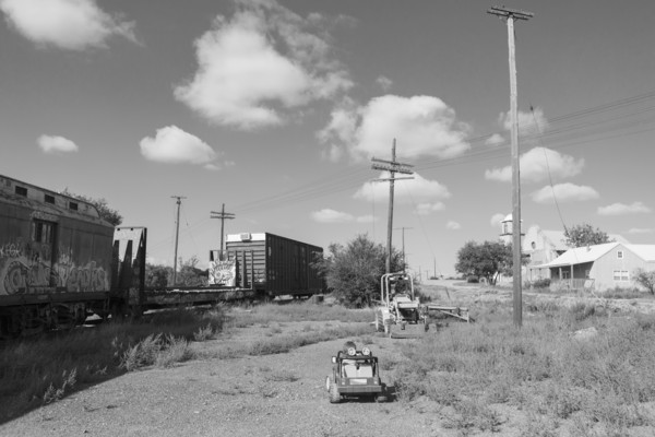 Caucasian boy driving toy car near train