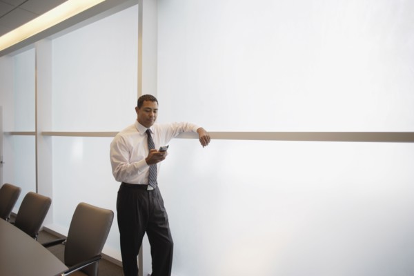 Hispanic businessman looking at electronic organizer