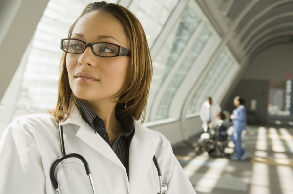 African doctor looking pensive in corridor
