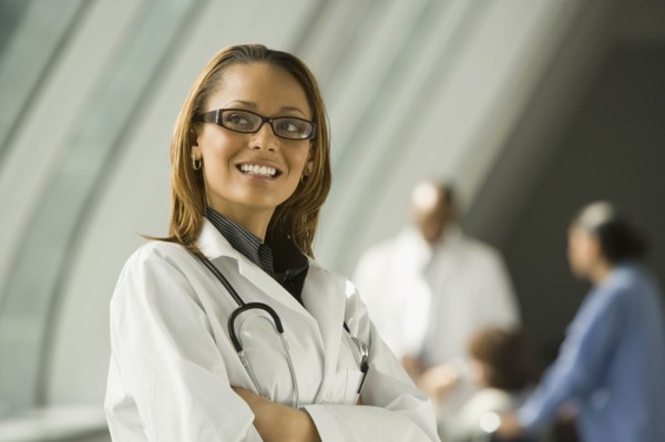 African doctor with arms crossed smiling