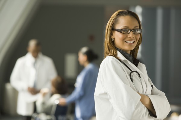 African doctor with arms crossed smiling