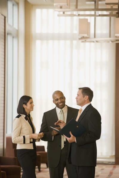 Multi-ethnic business people talking in corridor
