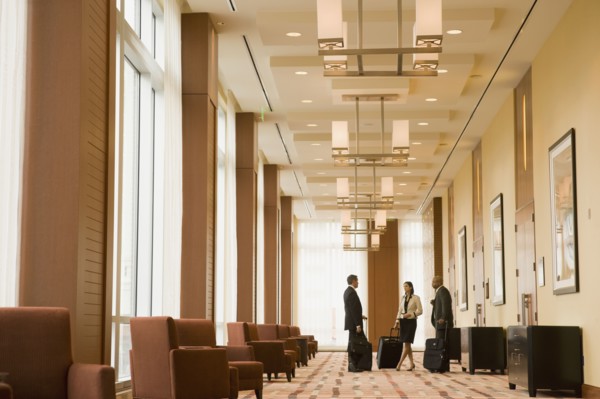 Multi-ethnic business people with suitcases in hotel