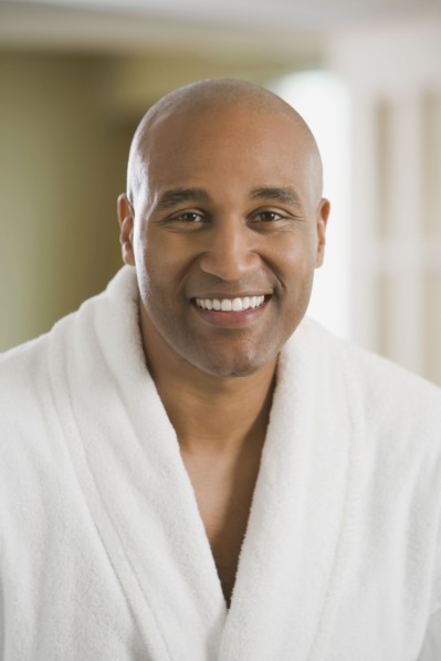 African man smiling in bathrobe