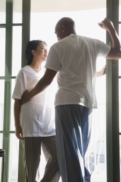 African couple in pajamas hugging