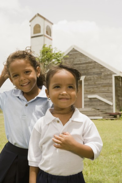 Hispanic sisters standing outside church