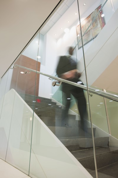 African American businessman descending staircase