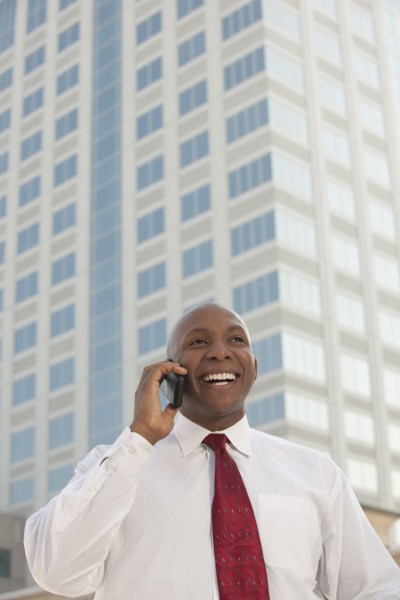 Black businessman talking on cell phone outdoors