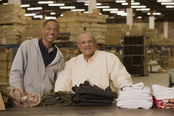 Manager standing with worker in warehouse