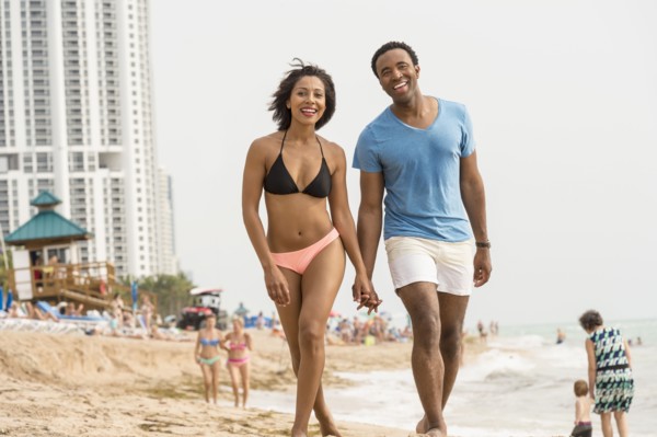 Couple holding hands on beach