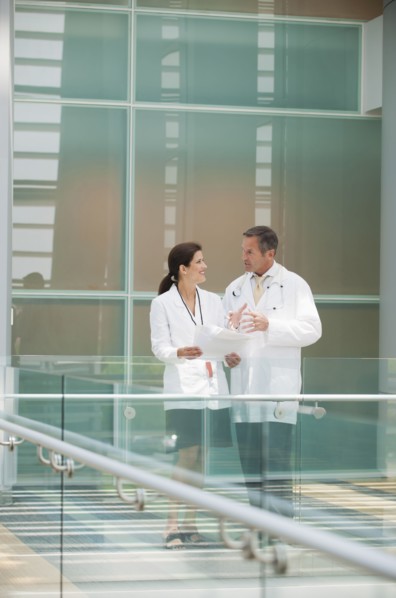 Doctors talking together near hospital railing