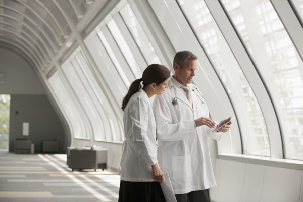 Doctors talking together in hospital corridor