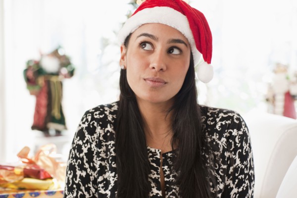 Hispanic woman wearing Santa hat