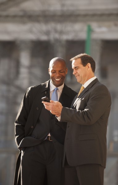 Businessmen looking at cell phone