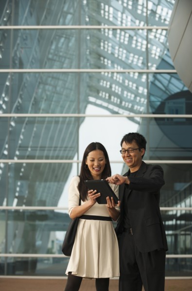 Asian business people using digital tablet