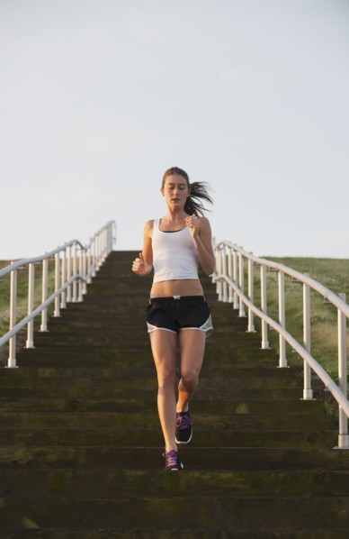 Caucasian woman running down steps