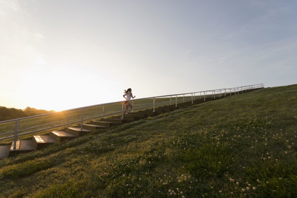 Caucasian woman running up steps