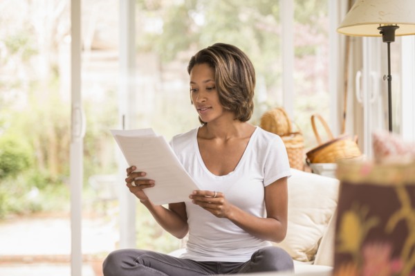 African American woman reading paperwork