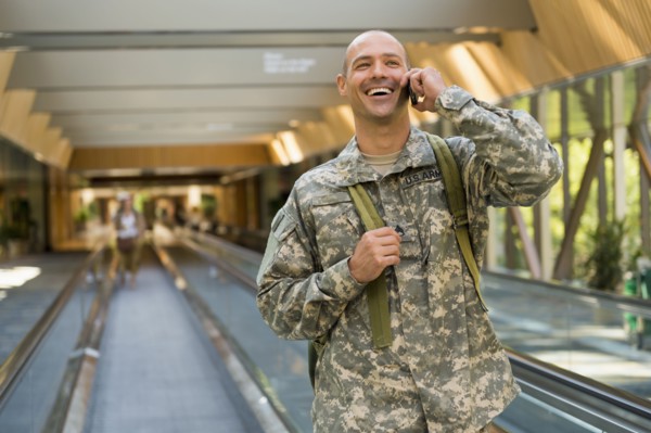 Caucasian soldier talking on cell phone in airport
