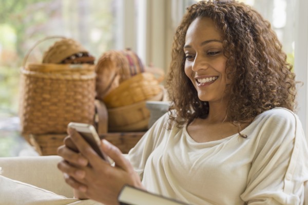 African American woman texting on cell phone