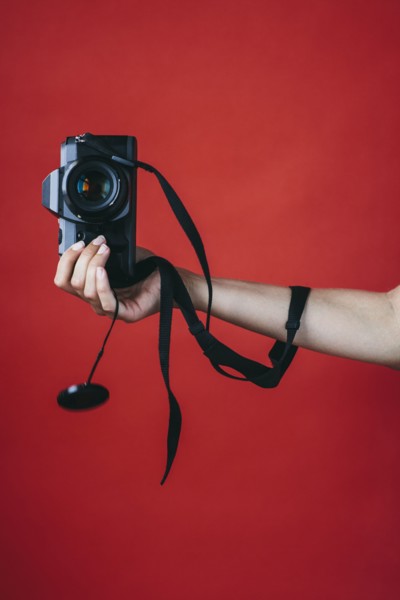 Hand of woman holding camera