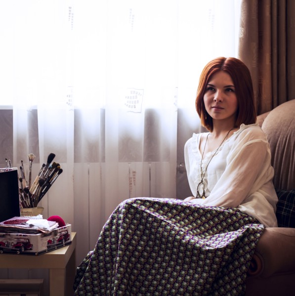 Caucasian woman sitting in armchair near window