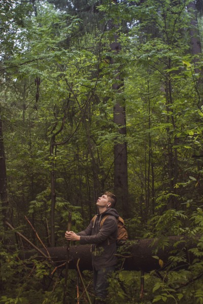 Caucasian man walking in forest