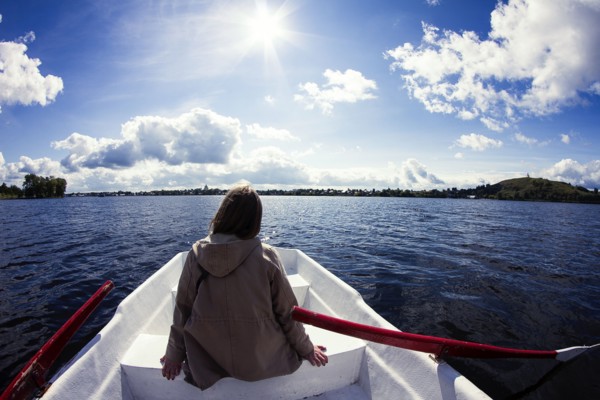 Caucasian woman sitting in rowboat