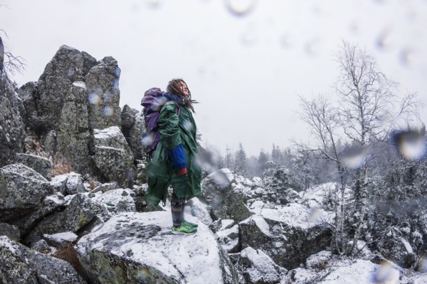 Caucasian hiker standing on rocky hillside