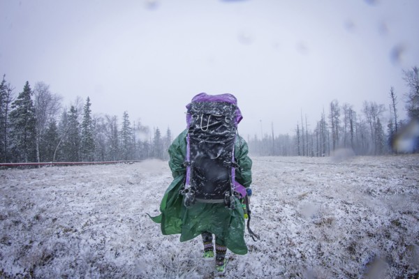 Caucasian hiker standing in frosty field