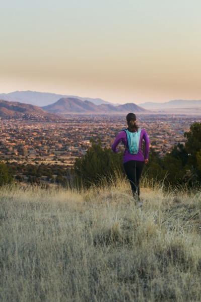 Hispanic woman running in remote area