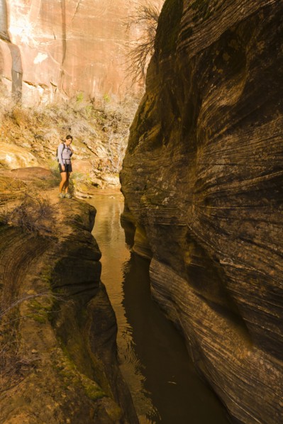 Persian woman hiking near canyon stream