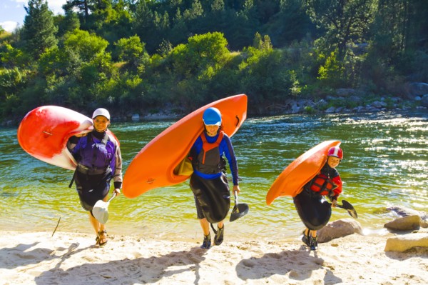 Caucasian family carrying kayaks