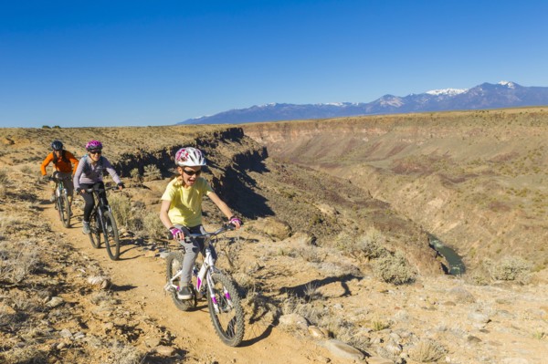 Family mountain biking near canyon